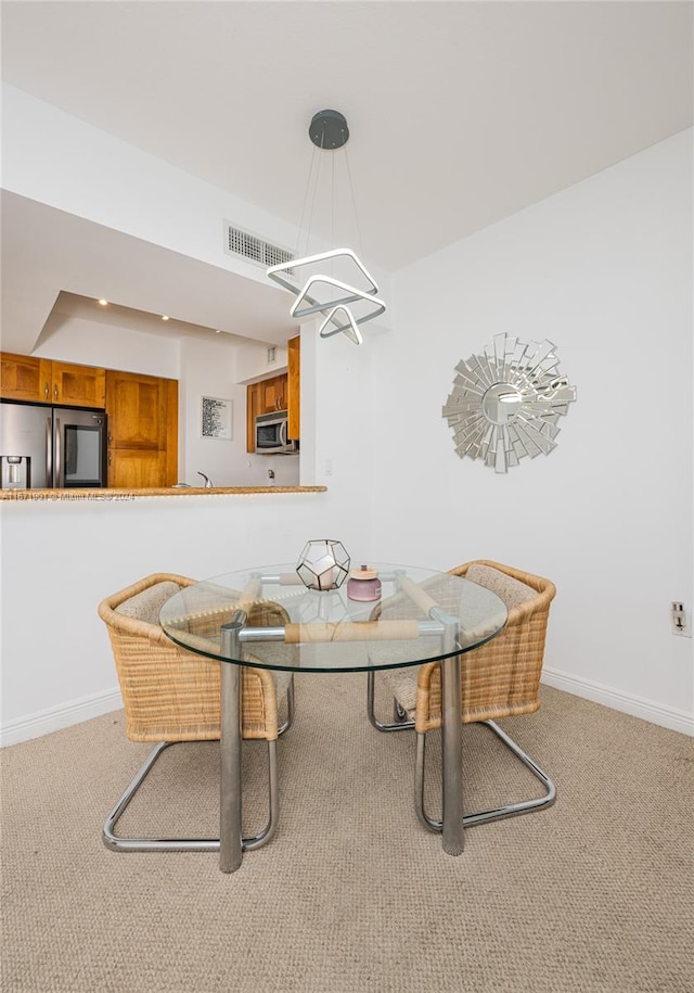 dining area with light carpet