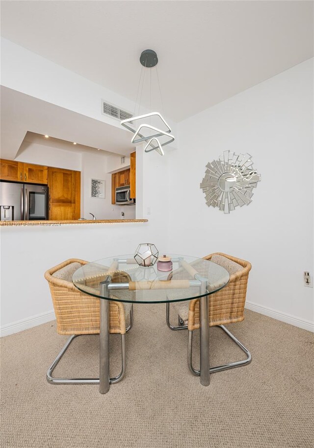 1745 E Hallandale Beach Blvd Unit 1804W, Hallandale Beach, FL 33009 - dining area featuring carpet floors, a notable chandelier, baseboards, and visible vents