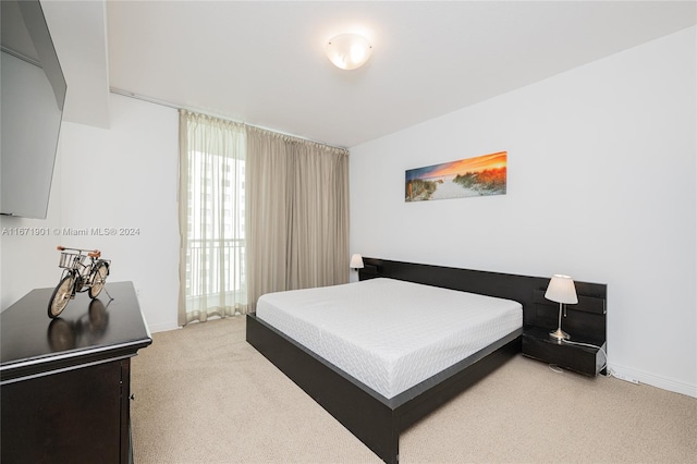 bedroom featuring light colored carpet