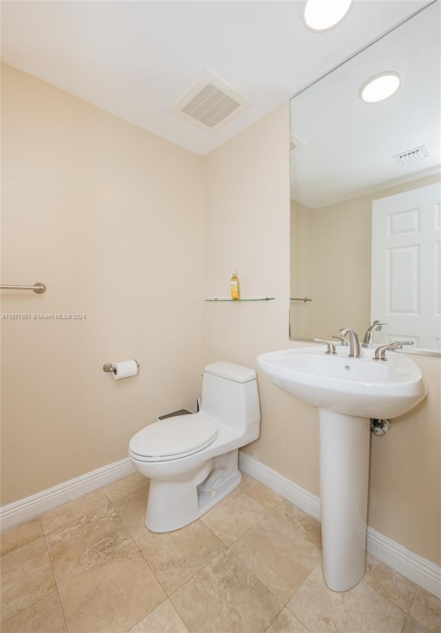 1745 E Hallandale Beach Blvd Unit 1804W, Hallandale Beach, FL 33009 - half bathroom featuring visible vents, a sink, baseboards, and toilet