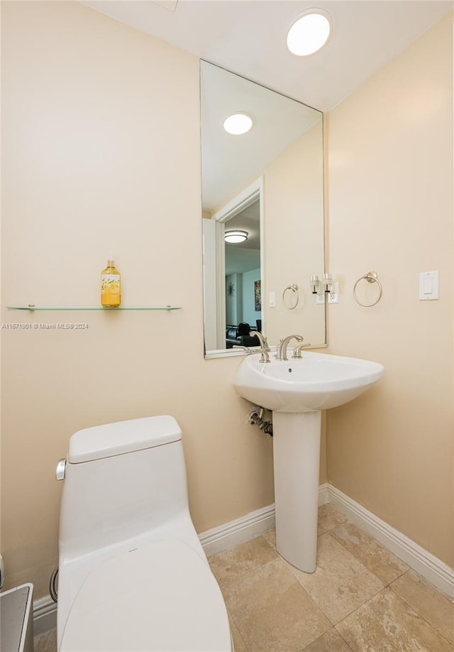 bathroom with tile patterned flooring and toilet