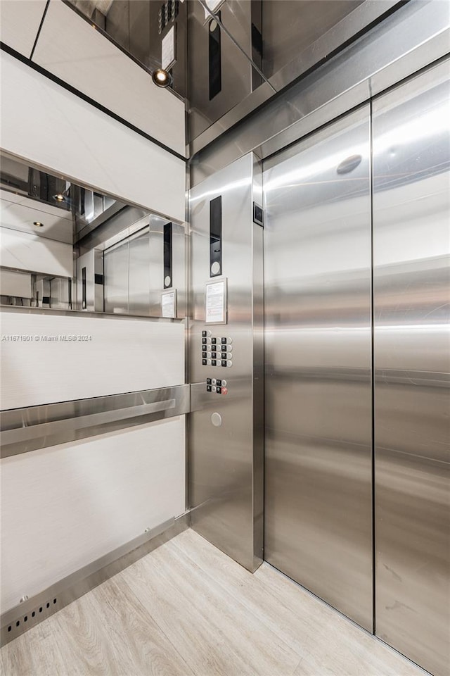 kitchen featuring light wood-type flooring and elevator