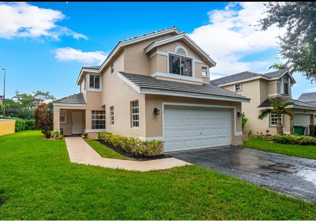 2913 Myrtle Oak Cir, Davie, FL 33328 - traditional home with a garage, asphalt driveway, stucco siding, a front lawn, and a tile roof