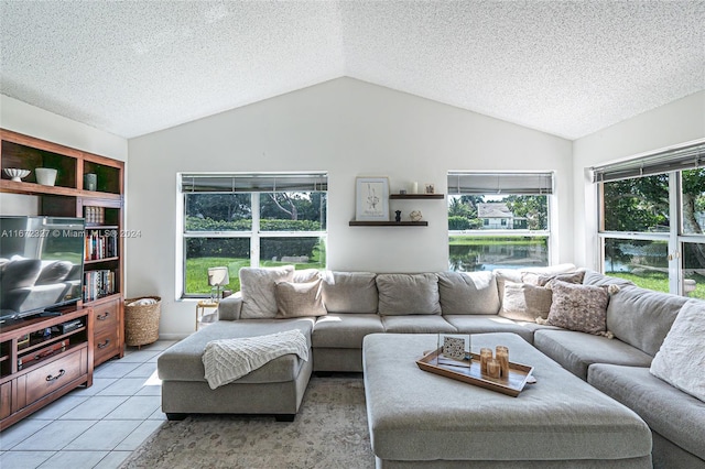 living room featuring lofted ceiling, light tile patterned flooring, and a textured ceiling