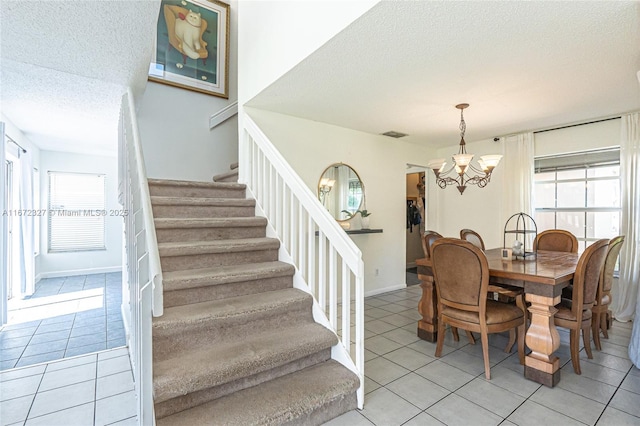 2913 Myrtle Oak Cir, Davie, FL 33328 - dining space featuring a textured ceiling, light tile patterned floors, a chandelier, and stairway