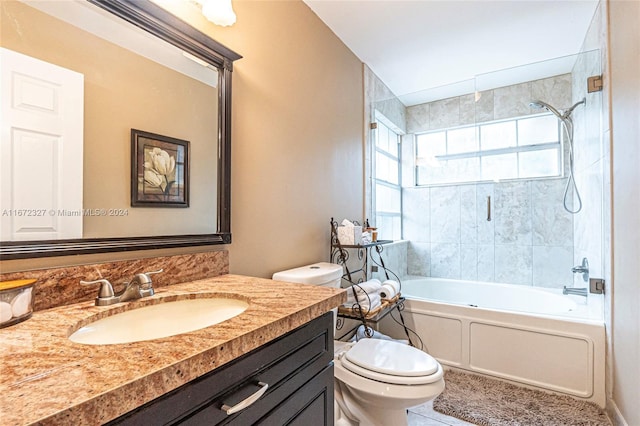 full bathroom featuring vanity, tile patterned floors, tiled shower / bath combo, and toilet