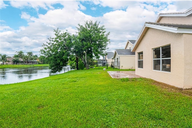 view of yard featuring a water view and a patio area