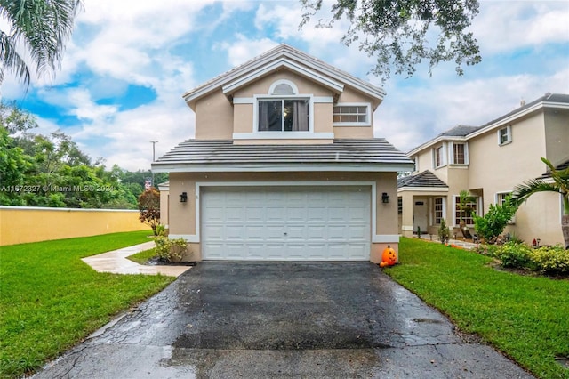 front facade with a garage and a front lawn