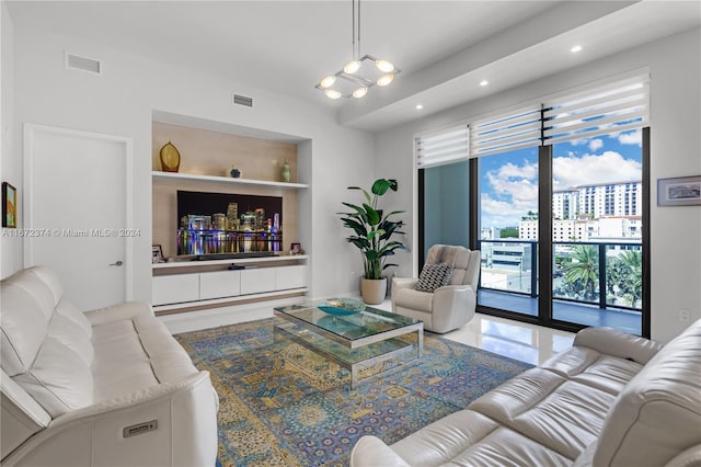 living room featuring a chandelier and built in features