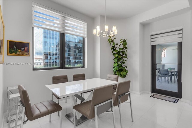 tiled dining area featuring a notable chandelier