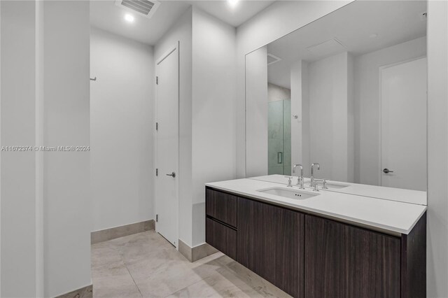 bathroom with walk in shower and vanity