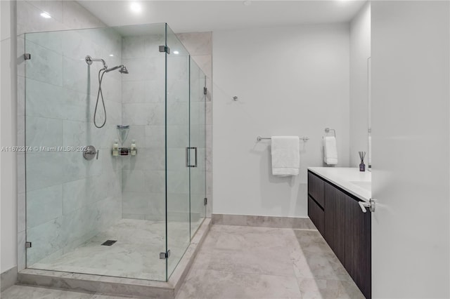 bathroom with walk in shower and vanity