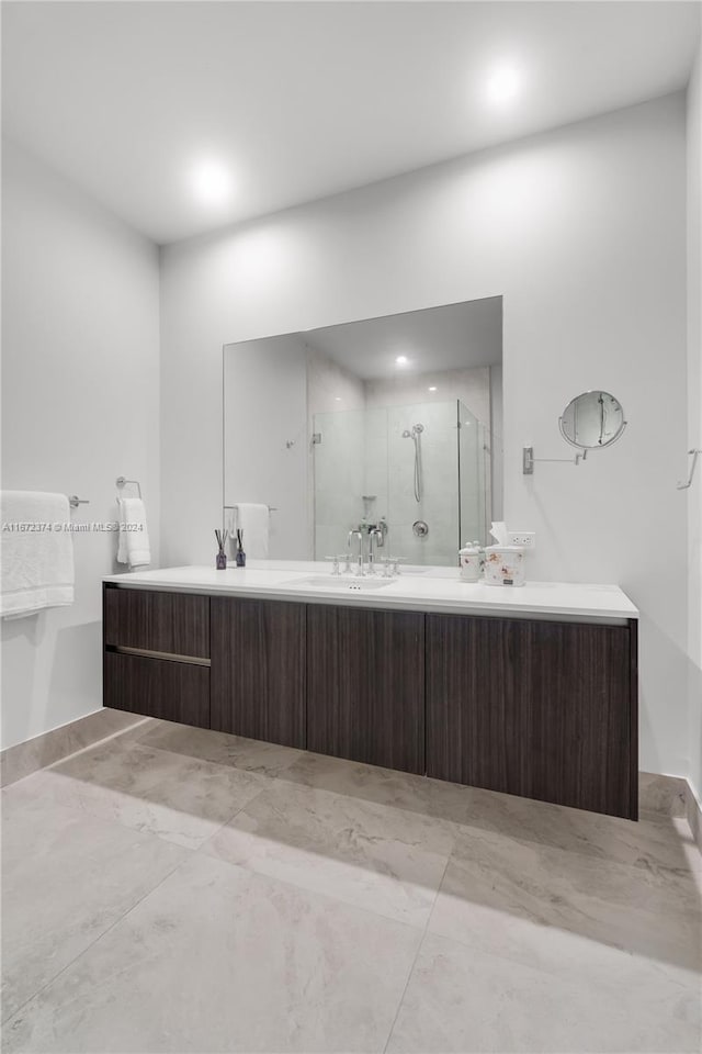 bathroom with vanity and a shower with door