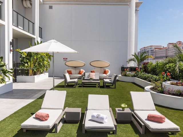 view of home's community featuring a patio and an outdoor hangout area