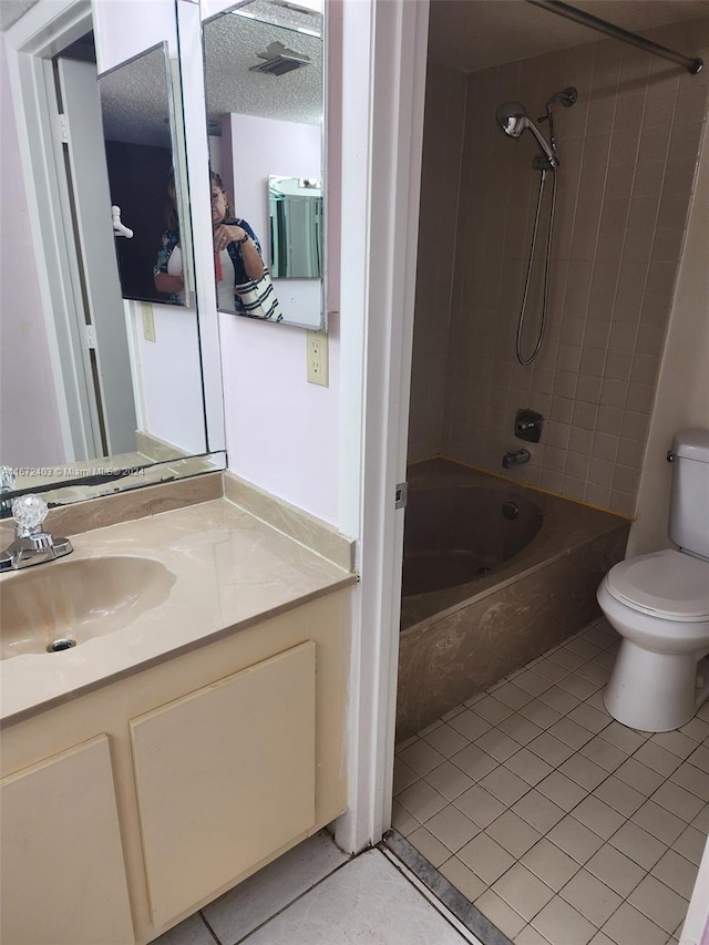 full bathroom with vanity, tiled shower / bath combo, tile patterned flooring, a textured ceiling, and toilet