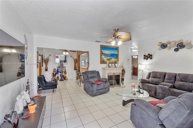 living room featuring ceiling fan and light tile patterned floors