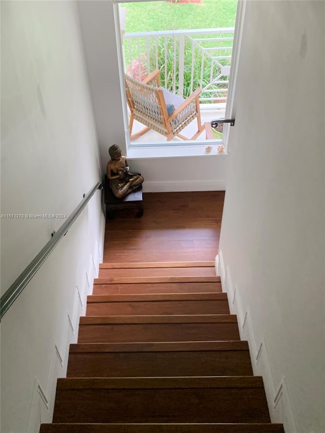 stairs featuring wood-type flooring