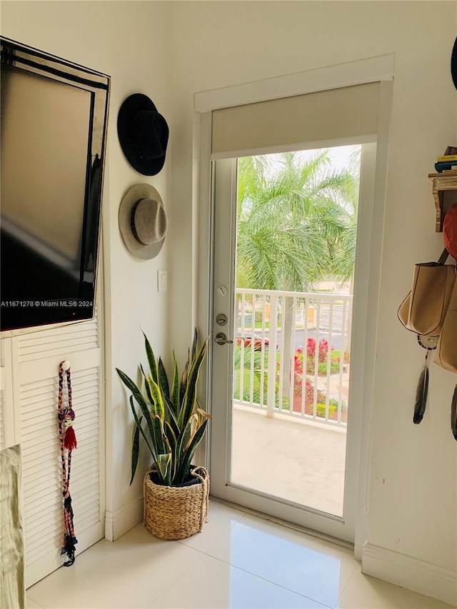 doorway to outside featuring a healthy amount of sunlight and tile patterned flooring