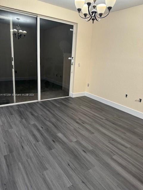 spare room with dark hardwood / wood-style flooring