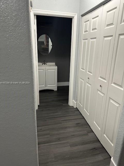 corridor with dark hardwood / wood-style flooring