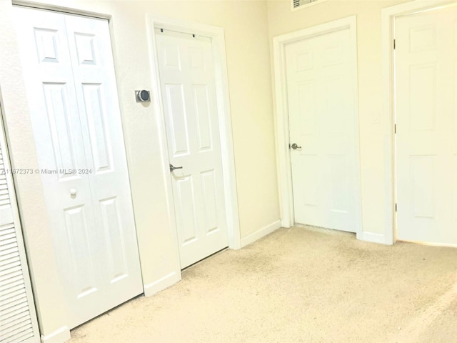 interior space featuring light colored carpet