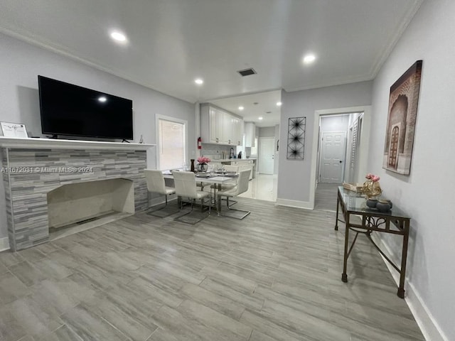 interior space featuring light wood-type flooring and crown molding