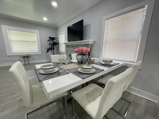 dining space with ornamental molding and hardwood / wood-style floors