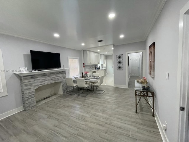 dining area with crown molding and light hardwood / wood-style flooring