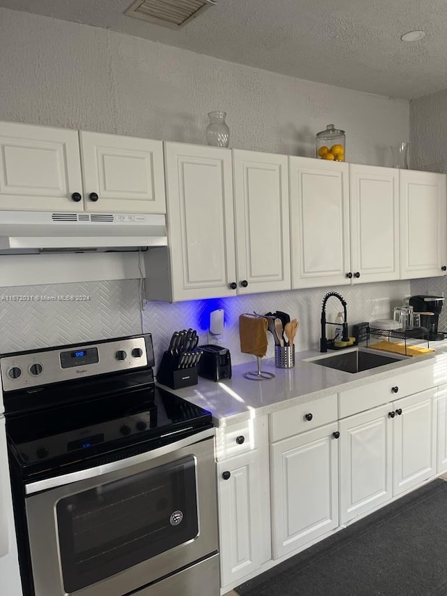 kitchen with white cabinetry, electric range, and sink