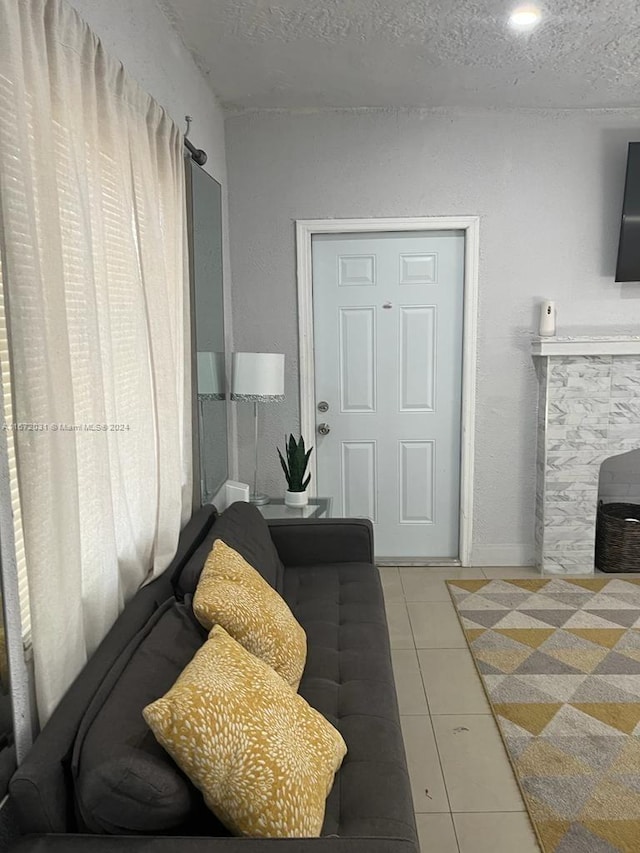 tiled living room with a textured ceiling