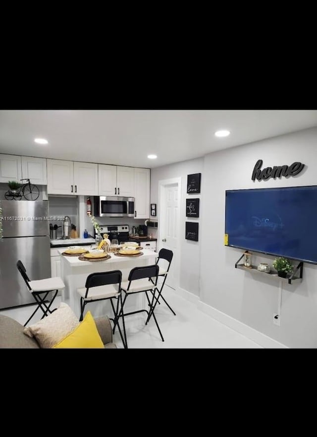 kitchen featuring stainless steel appliances and white cabinets