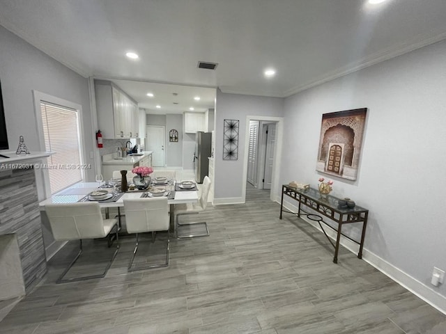 dining space featuring light hardwood / wood-style flooring and sink