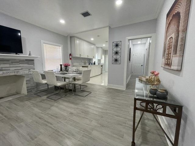 dining space with light hardwood / wood-style flooring and sink