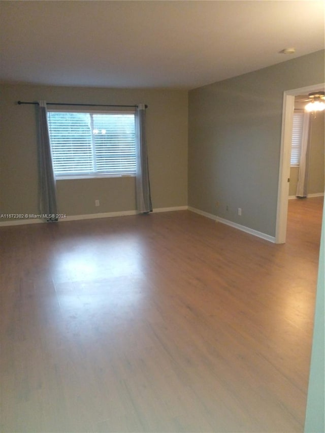 empty room featuring wood-type flooring and ceiling fan