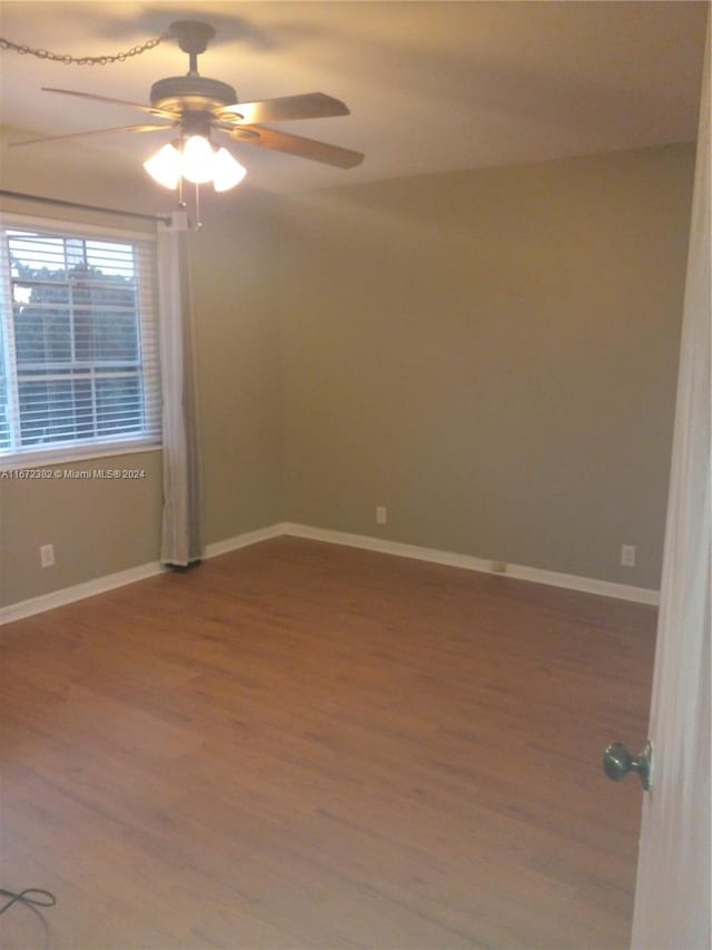 empty room with ceiling fan and hardwood / wood-style flooring