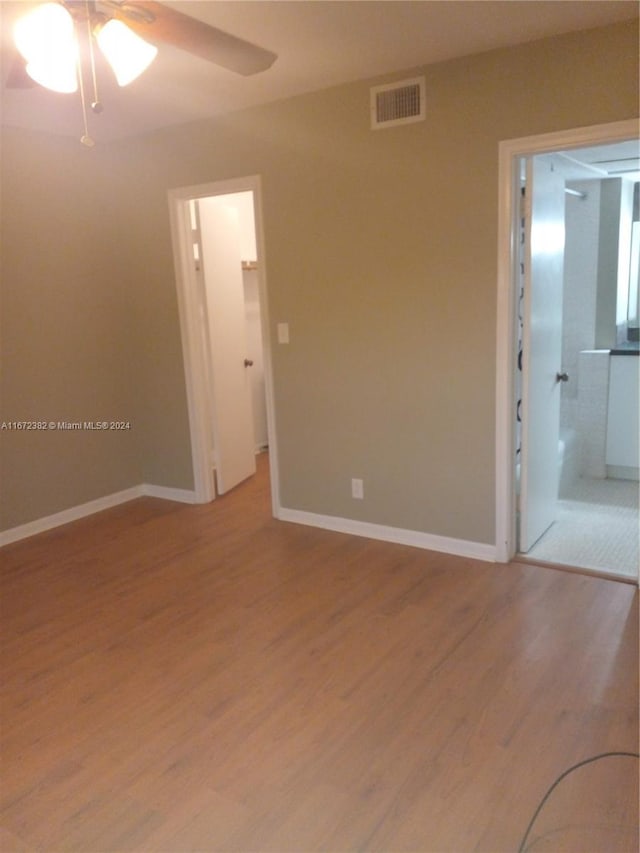 spare room with wood-type flooring and ceiling fan