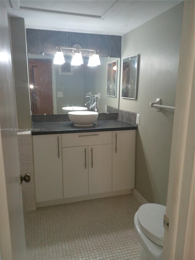 bathroom with vanity, toilet, and tile patterned floors