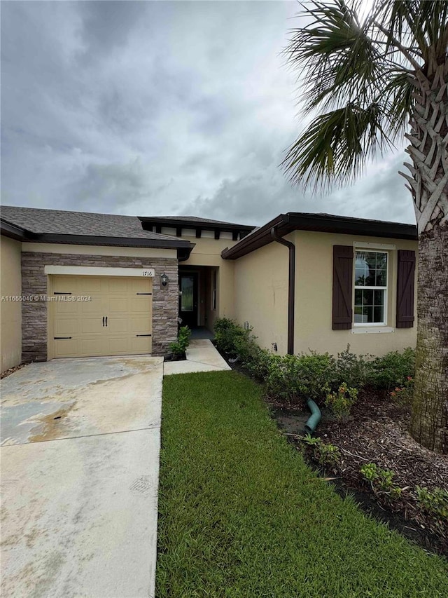 view of front facade with a front yard and a garage