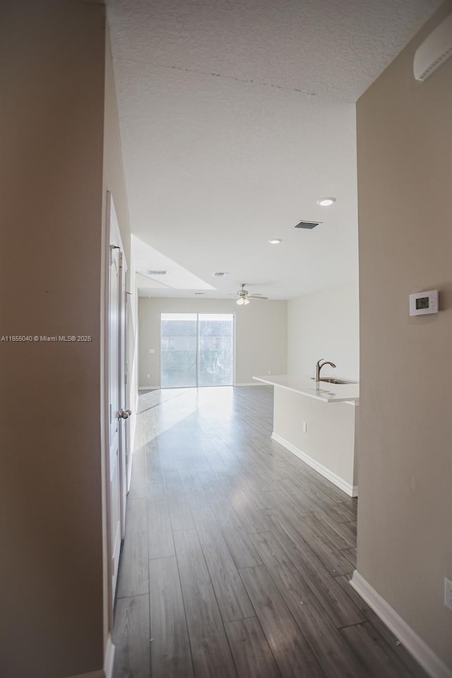 hallway with dark hardwood / wood-style flooring