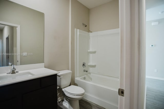 full bathroom with shower / bathtub combination, wood-type flooring, toilet, and vanity