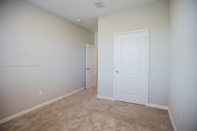 unfurnished bedroom featuring light carpet