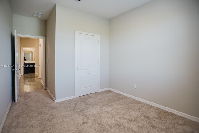 unfurnished bedroom with light carpet