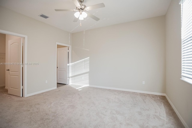 carpeted empty room with ceiling fan