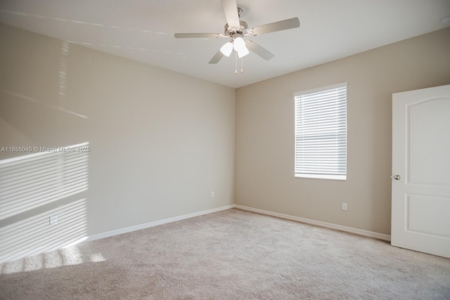 empty room featuring light carpet and ceiling fan