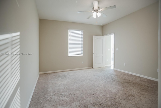 carpeted spare room with ceiling fan