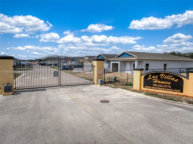 exterior space with a gate, a gated entry, and curbs