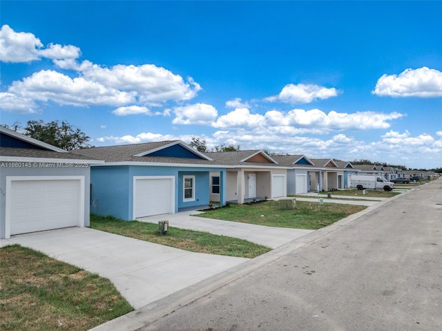 ranch-style home featuring a garage, a residential view, driveway, and stucco siding