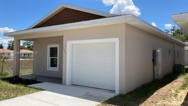 view of side of home featuring central air condition unit, fence, and stucco siding