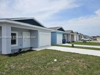 view of property exterior with a lawn and a garage