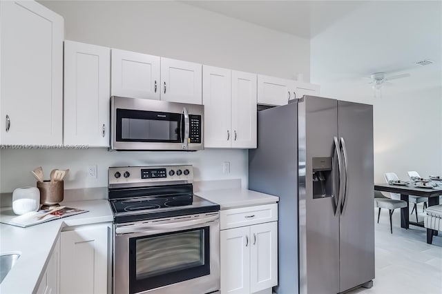 kitchen with visible vents, ceiling fan, appliances with stainless steel finishes, light countertops, and white cabinetry